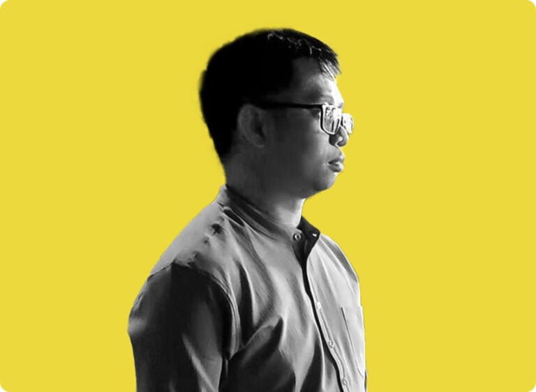 a man in glasses looking to side